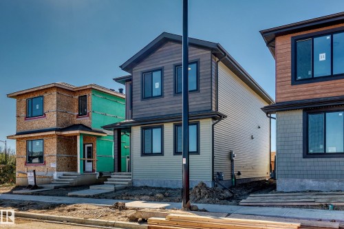 Two-story construction featuring horizontal siding and dark-trimmed windows - 9 Tilia Place, Spruce Grove, AB 