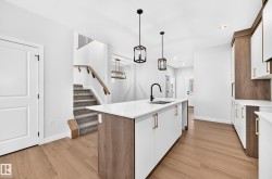 Modern kitchen island with a white countertop and integrated sink - 
