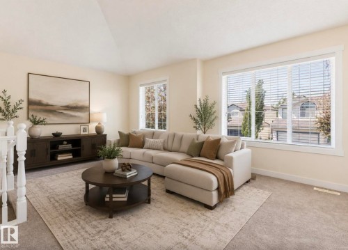 Bright living area featuring neutral-toned walls, expansive windows with white blinds, and soft carpeting - 1007 Macewan Close Sw, Edmonton, AB - Indoor Photo Showing Living Room