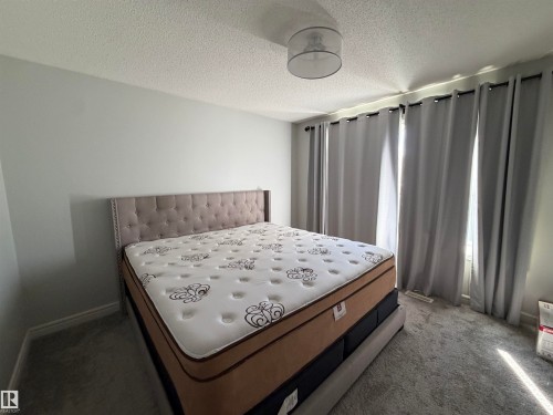 Recessed ceiling light fixture and light-toned walls - 2628 Donaghey Crescent Sw, Edmonton, AB 