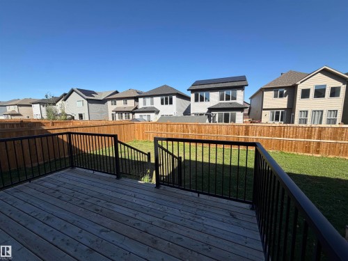 Spacious wood-finish deck with black metal railings - 2628 Donaghey Crescent Sw, Edmonton, AB 