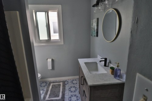 Custom vanity with integrated rectangular sink and matte black faucet - 4113 - 42 B Ave, Leduc, AB 