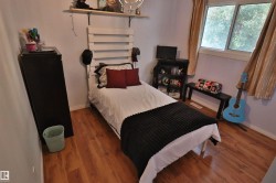 Wood-finish flooring, white walls, and a window with natural light - 