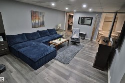 Recessed lighting, wood-finish flooring, and light gray wall paint - 