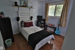 Wood-finish flooring, single window, and light-toned walls - 