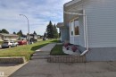 Bay window with white trim, light blue siding, stucco foundation, concrete walkway with steps, and landscaping with white rock and planters - 4113 - 42 B Ave, Leduc, AB 