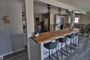 Wood-finish flooring throughout, complemented by a substantial wood-finish countertop - 4113 - 42 B Ave, Leduc, AB 