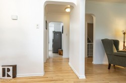Hardwood flooring and arched doorways define this interior space - 