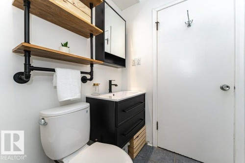 Modern vanity with an integrated sink and black faucet - 10507 67 Avenue Nw, Edmonton, AB 