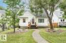 White siding exterior with a dark shingle roof - 10507 67 Avenue Nw, Edmonton, AB 
