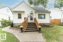 White siding exterior with a dark-shingled roof - 10507 67 Avenue Nw, Edmonton, AB 