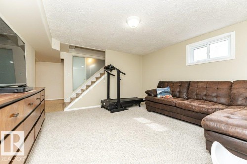Carpeted flooring, neutral wall paint, and a white-framed window - 10507 67 Avenue Nw, Edmonton, AB 