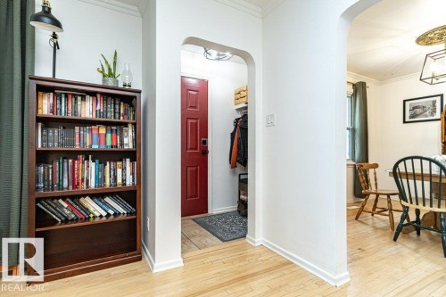Hardwood flooring, arched doorways, crown molding, and a red panel door - 10507 67 Avenue Nw, Edmonton, AB 