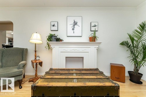 Decorative white fireplace mantel with carved accents - 10507 67 Avenue Nw, Edmonton, AB 
