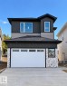 Contemporary exterior featuring dark vertical siding, light horizontal siding, white brick accents, a white garage door with upper lites, and a concrete driveway - 47 Meadowgrove Lane, Spruce Grove, AB 