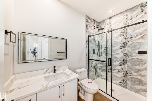 Vanity with a rectangular undermount sink, quartz countertop, and matte black faucet - 47 Meadowgrove Lane, Spruce Grove, AB 