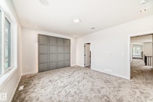 Wall-to-wall carpeting, recessed lighting, large window, paneled accent wall, built-in ceiling speakers - 47 Meadowgrove Lane, Spruce Grove, AB 