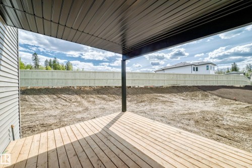 Covered patio with wood-finish decking, black support column, and a slatted ceiling - 47 Meadowgrove Lane, Spruce Grove, AB 