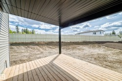 Covered patio with wood-finish decking, black support column, and a slatted ceiling - 