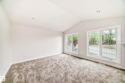 Vaulted ceiling, recessed lighting, expansive windows, light-toned carpeting, and neutral wall finishes - 47 Meadowgrove Lane, Spruce Grove, AB 