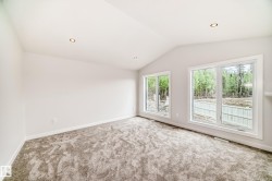 Vaulted ceiling, recessed lighting, expansive windows, light-toned carpeting, and neutral wall finishes - 