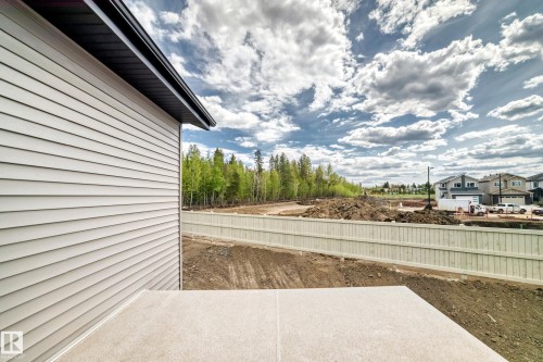Concrete patio with a durable privacy fence - 47 Meadowgrove Lane, Spruce Grove, AB 