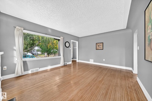 Bright natural Light Living Rood with Original Refinished Hardwood Flooring - 12045 64 Street Nw, Edmonton, AB 