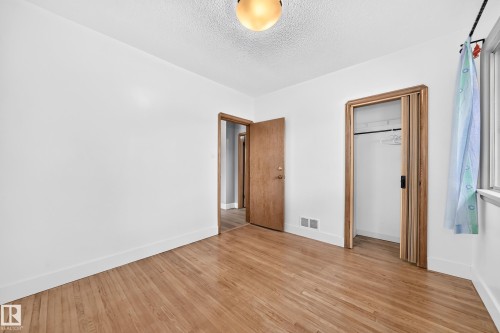 Bedroom with large Window and Hardwood Flooring - 12045 64 Street Nw, Edmonton, AB 