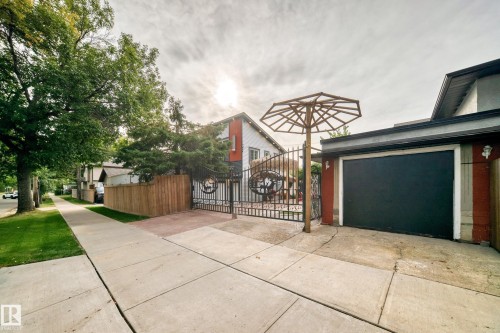 Attached garage with Wrought Iron Gate to Yard - 12045 64 Street Nw, Edmonton, AB 