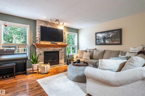 Stone-faced fireplace with a wood mantel - 38 Dubonnet Way, St. Albert, AB 