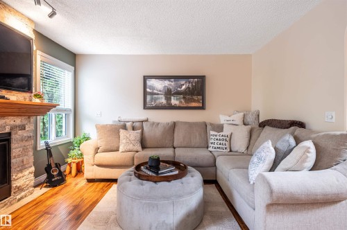Stone-clad fireplace with wood mantel - 38 Dubonnet Way, St. Albert, AB 