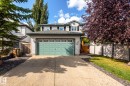 Two-story residence with siding exterior, attached garage, and paved driveway - 38 Dubonnet Way, St. Albert, AB 