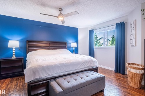 Wood-finish flooring with a contrasting accent wall - 38 Dubonnet Way, St. Albert, AB 