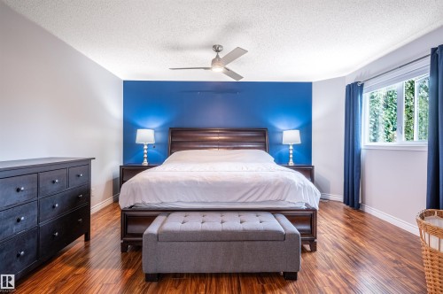 Rich wood-finish flooring, bright window with natural light, and a ceiling fan for comfort - 38 Dubonnet Way, St. Albert, AB 