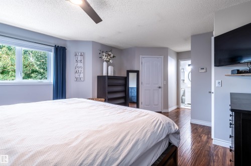 Wood-finish flooring throughout, ceiling fan, and painted interior walls - 38 Dubonnet Way, St. Albert, AB 