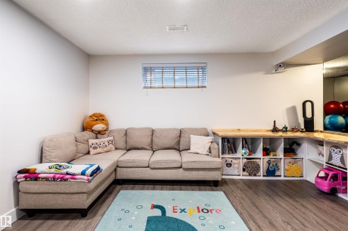 Wood-finish flooring with white walls and a window featuring horizontal blinds - 38 Dubonnet Way, St. Albert, AB 