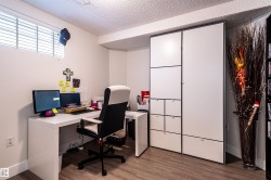 Wood-finish flooring, white walls, and a small window with blinds - 