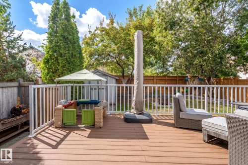 Expansive wood-finish deck with white railings - 38 Dubonnet Way, St. Albert, AB 