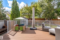 Expansive wood-finish deck with white railings - 