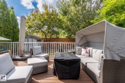 Expansive outdoor deck with wood-finish flooring and white picket railing - 