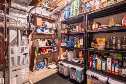 Utility area with exposed ceiling joists, ductwork, and a central forced-air unit - 38 Dubonnet Way, St. Albert, AB 