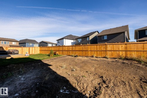 Expansive backyard space with a newly installed wood privacy fence - 2358 Muckleplum Way Sw, Edmonton, AB 
