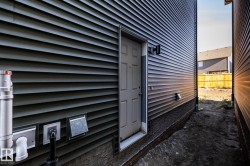 Dark gray horizontal siding with a side entry door - 
