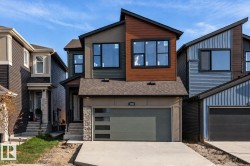 Contemporary two-story exterior with multi-toned siding, stone accents, and an attached two-car garage - 