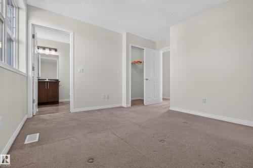 Carpeted flooring, neutral wall tones, and white trim throughout - 6933 21A Avenue Sw, Edmonton, AB 