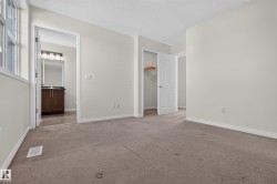 Carpeted flooring, neutral wall tones, and white trim throughout - 