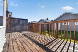 Wood-plank deck with a wood railing and privacy fencing - 