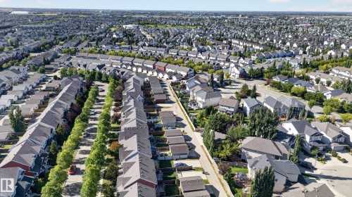Expansive residential neighborhood featuring numerous detached and semi-detached homes, mature street trees, and paved roadways - 6933 21A Avenue Sw, Edmonton, AB 