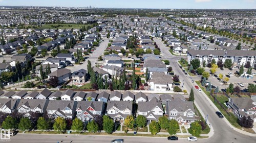 Expansive residential area featuring numerous detached homes with diverse architectural styles, tree-lined streets, and multiple apartment buildings - 6933 21A Avenue Sw, Edmonton, AB 