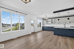 Open-concept living space with wood-finish flooring - 